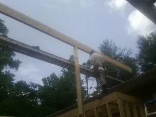 Carpenter setting a ridge beam over a new addition frame — Ice Dam Removal by Roofing Brothers in Boise
